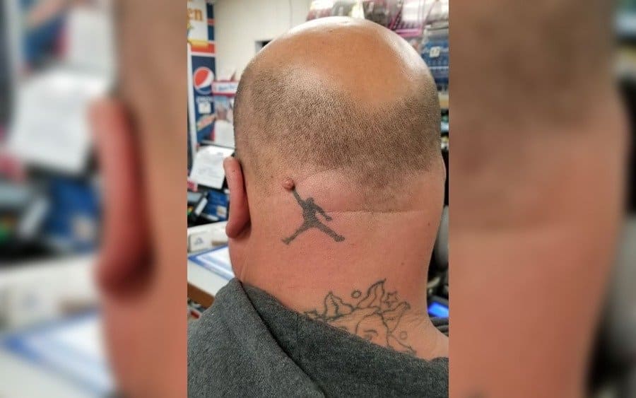 A tattoo of a guy playing basketball on a guy's head