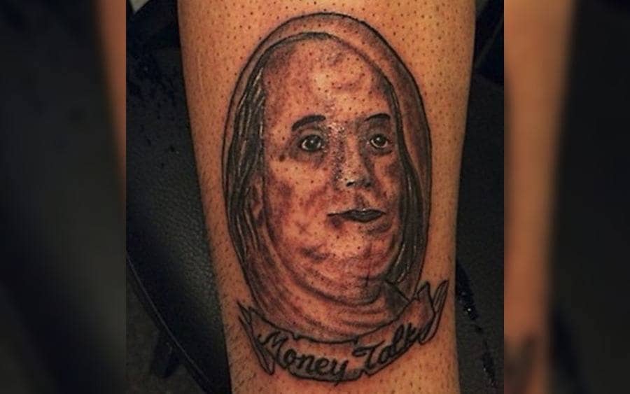 A tattoo of Benjamin Franklin on a guy's arm 