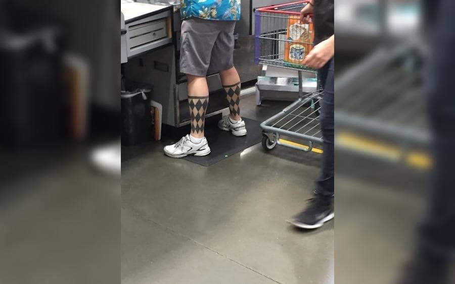 A tattoo of socks on a guy legs