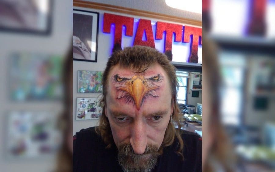 A tattoo of an eagle on a guy's forehead