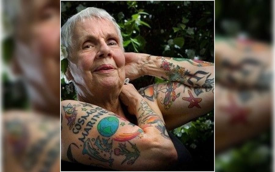 an old woman covered with tattoos