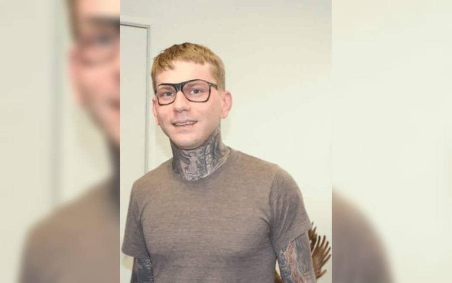 A tattoo of glasses on a guy's face