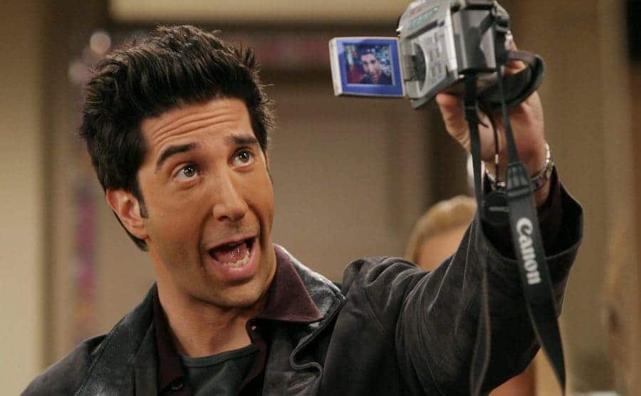 David Schwimmer filming himself with an old video recorder in a scene from Friends