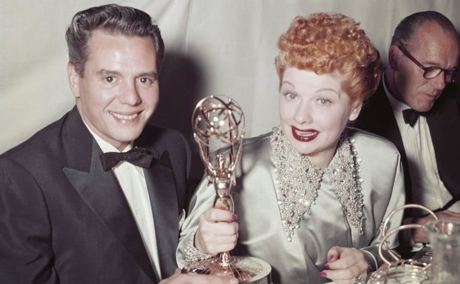 Desi Arnaz and Lucille Ball at a dinner table with their Emmy Award