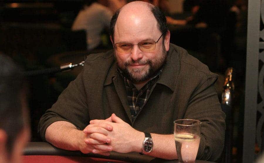 Jason Alexander sitting at a poker table