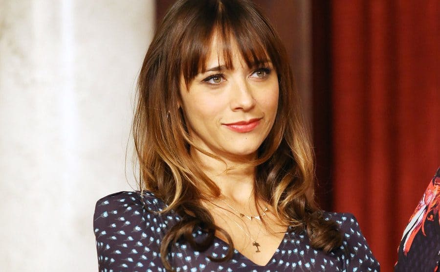 Rashida Jones smirking with her arms crossed