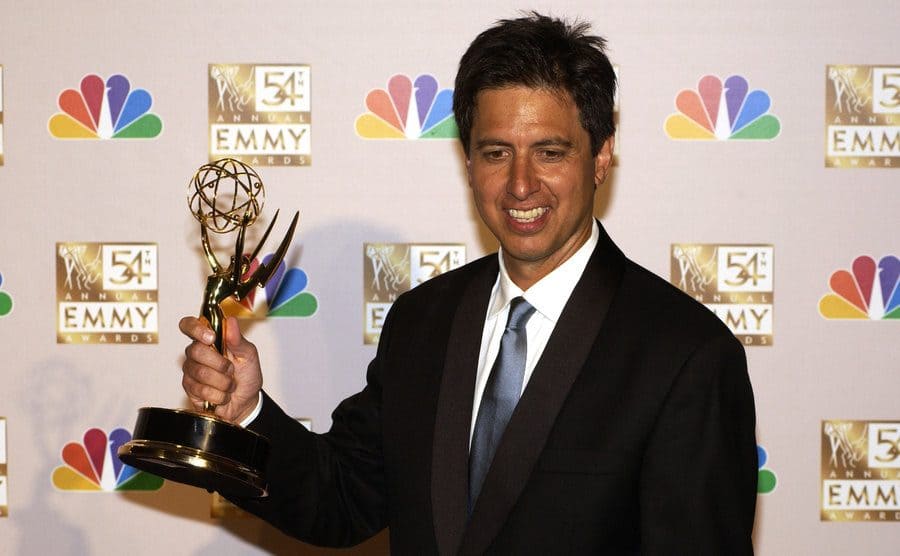 Ray Romano holding an Emmy Award on the red carpet