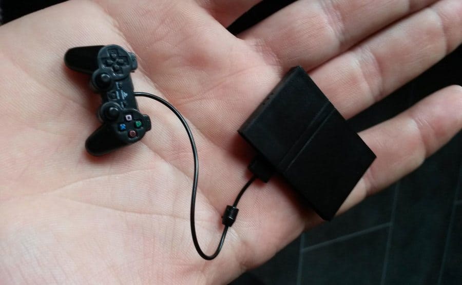 A miniature-sized PlayStation with a controller that fits in the palm of your hand.