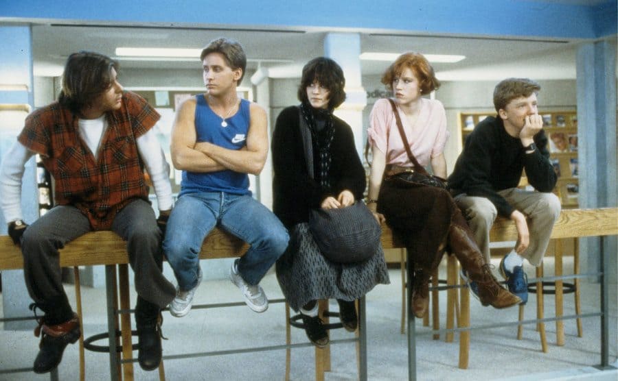 The cast of The Breakfast club sitting in the library