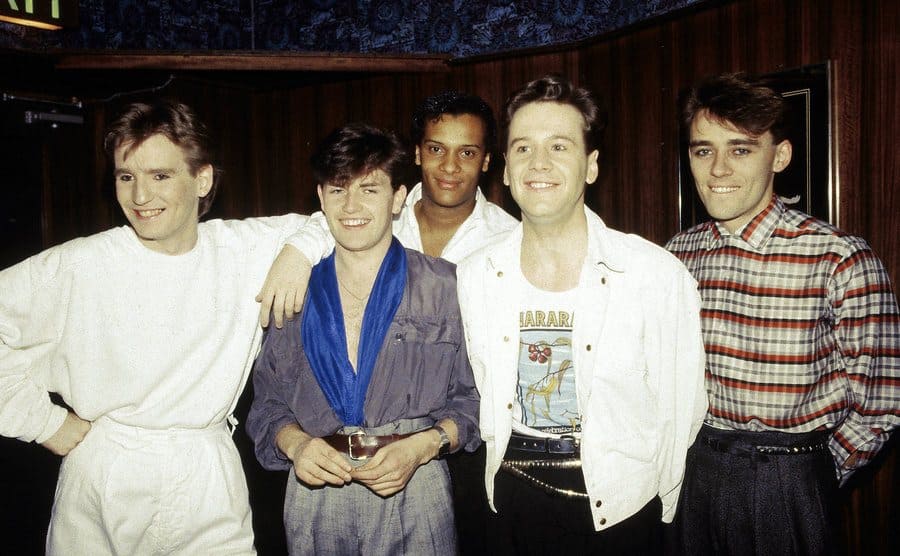 The band Simple Minds posing backstage