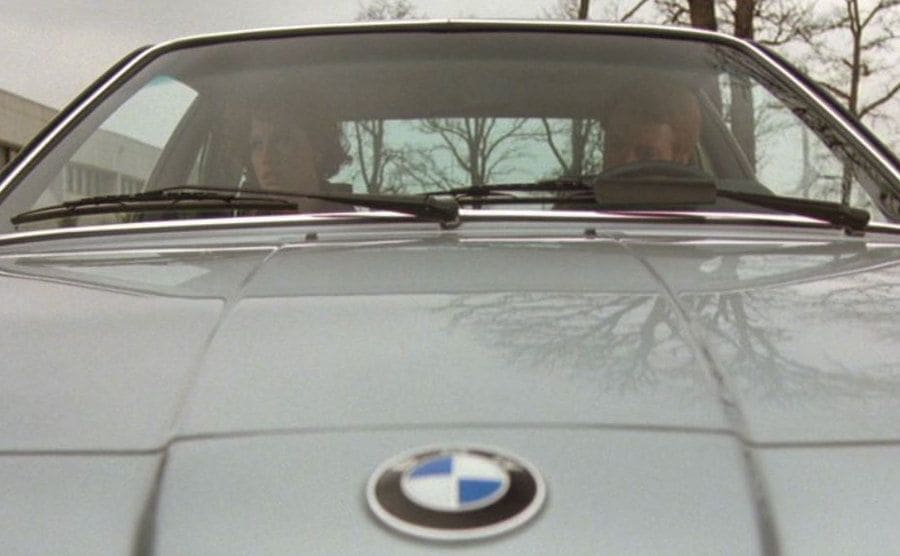 Molly Ringwald being dropped off by her father in the silver BMW