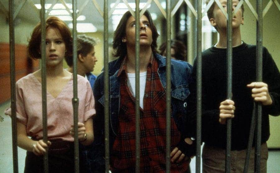 The five students in detention trying to get past a gate in the high school hallway
