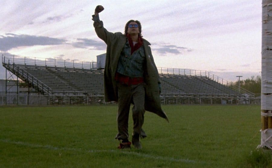 Judd Nelson with his first in the air walking off of the high school football field