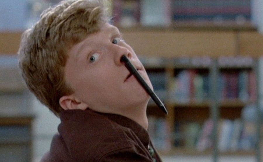 Anthony Michael Hall with a pencil up his nose in a scene from The Breakfast Club