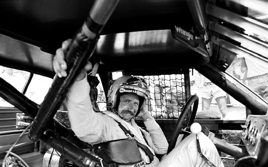 NASCAR driver Dale Earnhardt Sr. sits in his race car