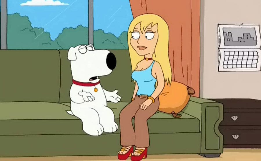 Brian and Jillian sitting on a couch talking in a scene from Family Guy
