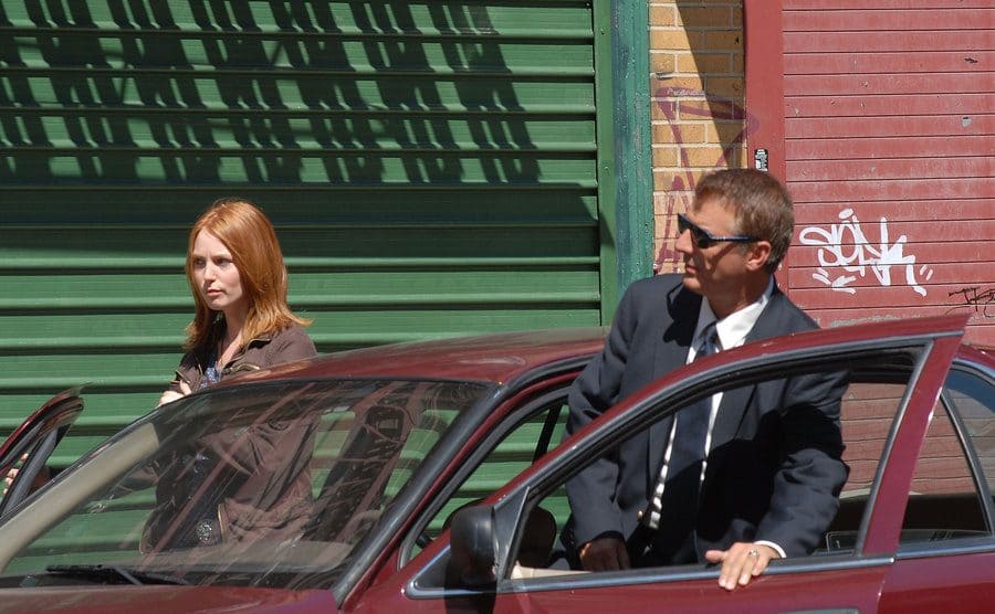 Chris Noth as Mike Logan and another detective getting into a car in a scene from Law and Order