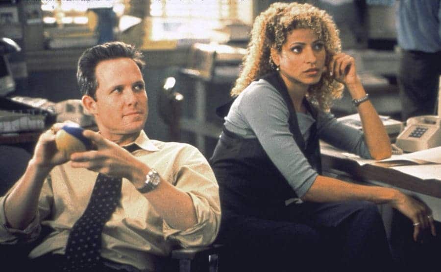 Michelle Hurd as Monique Jeffries sitting with Dean Winters in the precinct