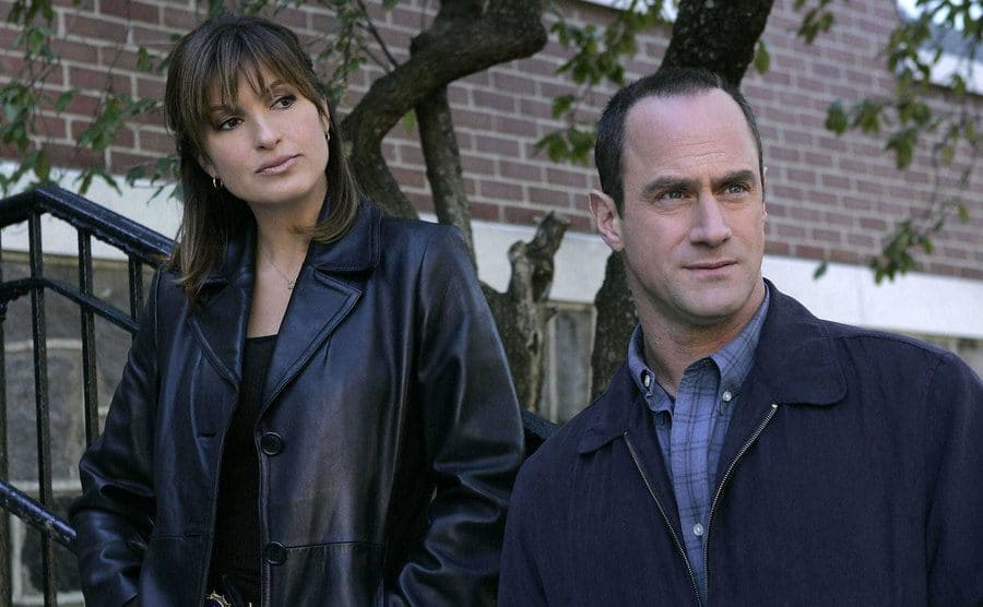 Mariska Hargitay and Christopher Meloni standing on front steps in a scene from Law and Order