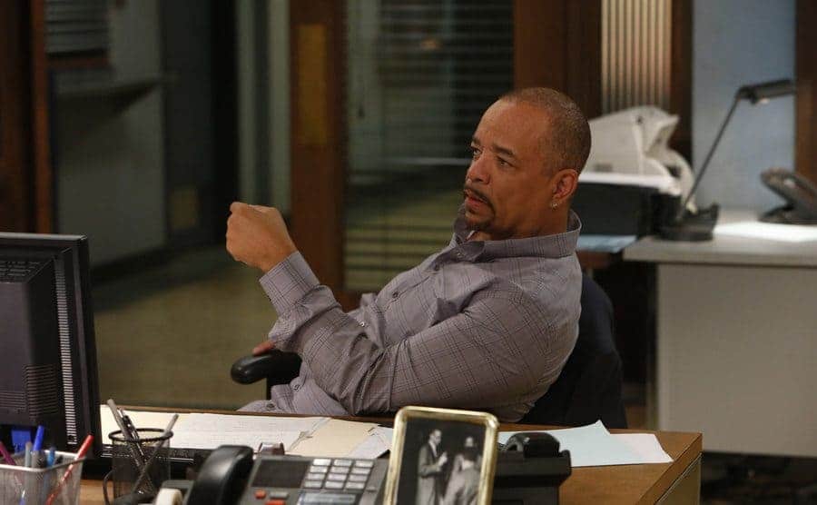 Ice T sitting behind his desk at the precinct