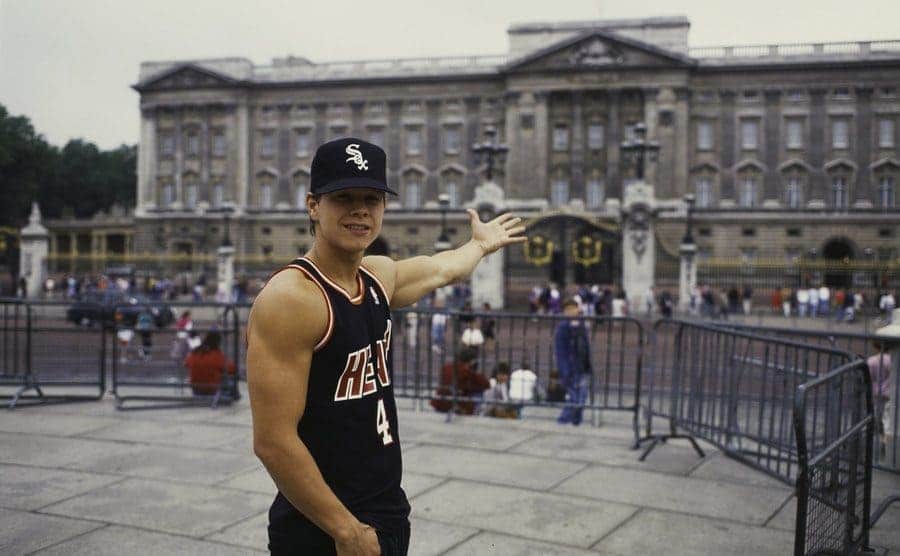 Mark Wahlberg standing outside of Buckingham Palace circa 1991