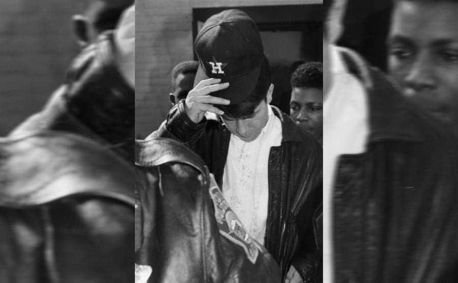 Mark Wahlberg with his head down leaving court