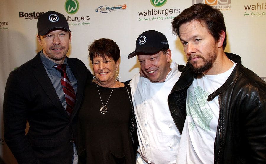 Donnie, Alma, Paul, and Mark Wahlberg posing together on the red carpet