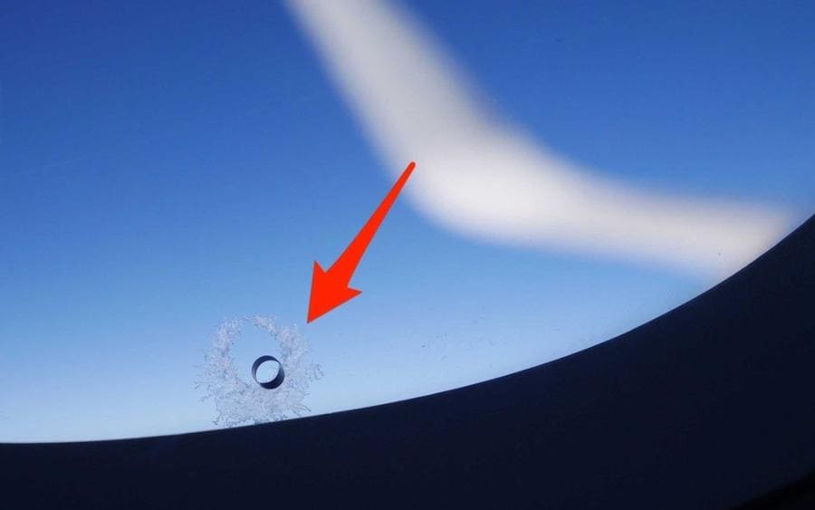 Airplane window breather hole