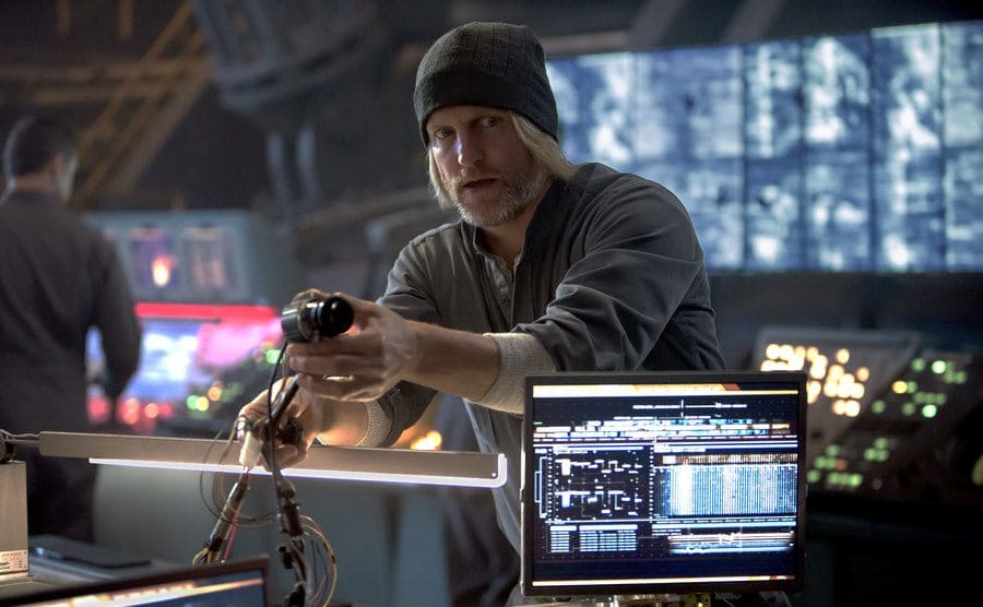Woody Harrelson adjusting a webcam in a room full of computers