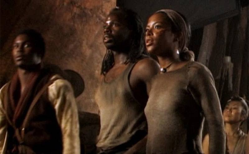 Aaliyah standing with others looking into the distance in The Matrix Reloaded