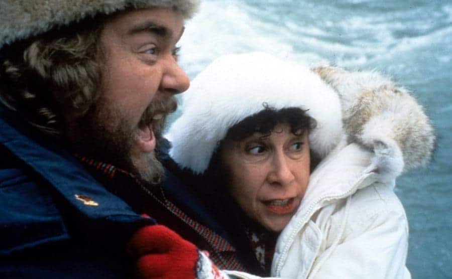 John Candy and Rhea Perlman bundled up for the winter looking scared