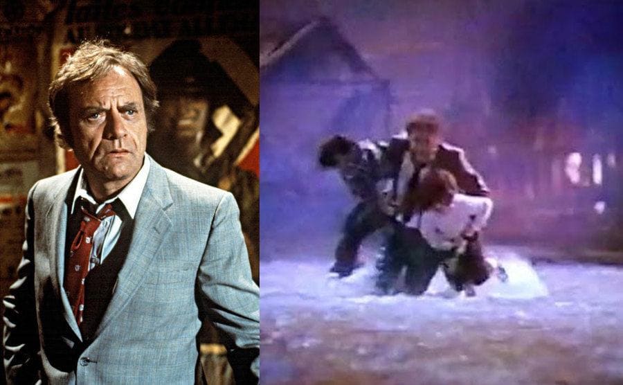 Vic Morrow looking worried in a scene from the Twilight Zone movie / Vic carrying the two child actors across the water
