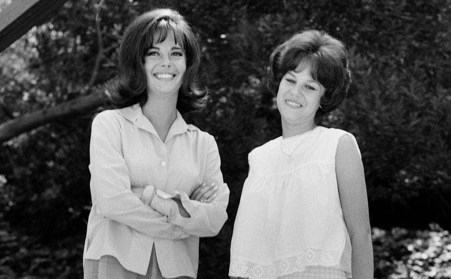 Natalie and Lana Woods posing for a portrait with woods behind them