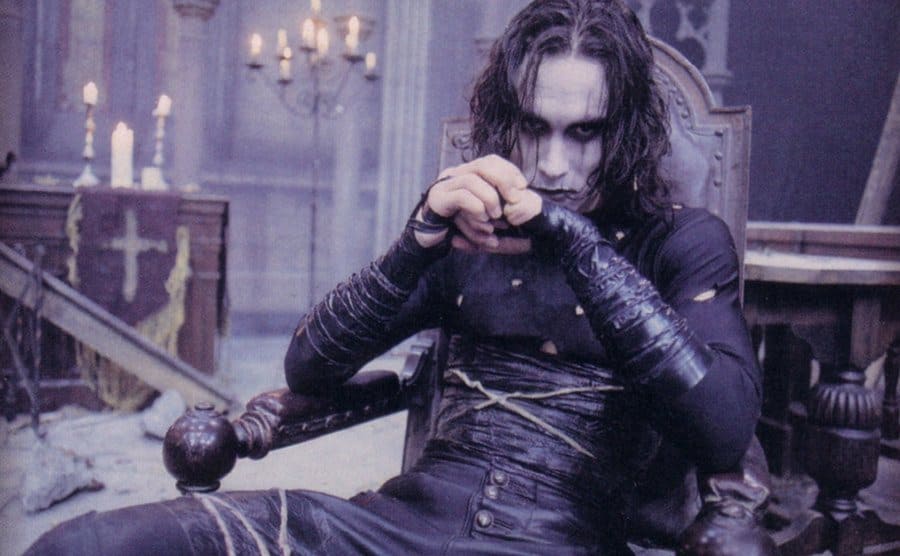 Brandon Lee sitting in make up in a chair in a deserted mansion