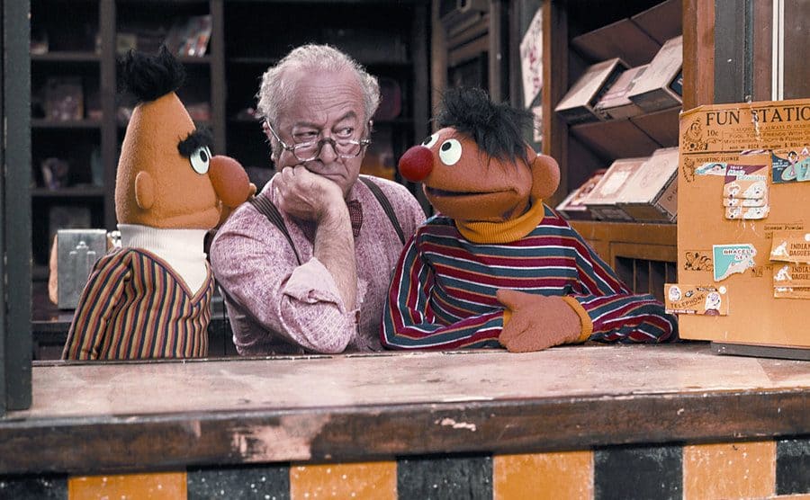 Ernie and Bert with Will Lee behind a counter in Sesame Street