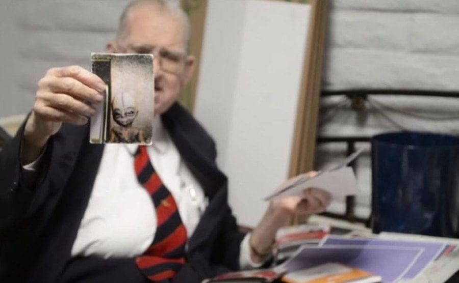 Boyd Bushman showing photographs of aliens from the time he worked in Area 51.