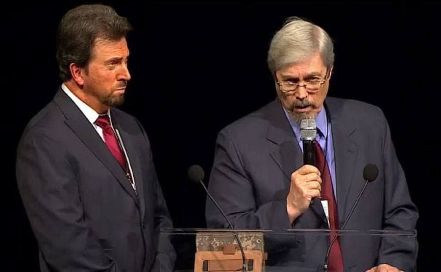 Tom Carey and Don Schmitt are speaking at a conference.