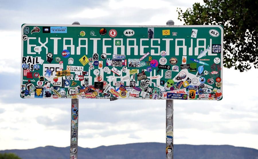 An Extraterrestrial Highway sign covered with stickers is seen along state route 375 on July 22, 2019.