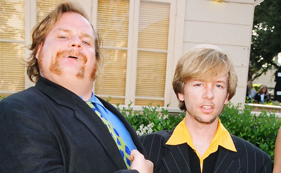 Chris Farley and David Spade arriving at an event