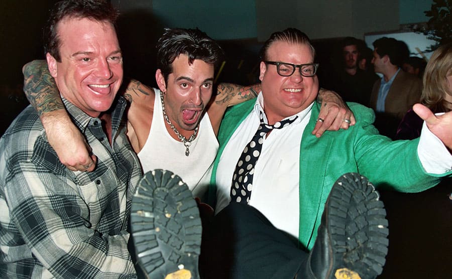 Tom Arnold, Tommy Lee, and Chris Farley posing at the Grammy Awards