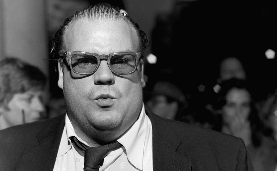 A black and white portrait of Chris Farley