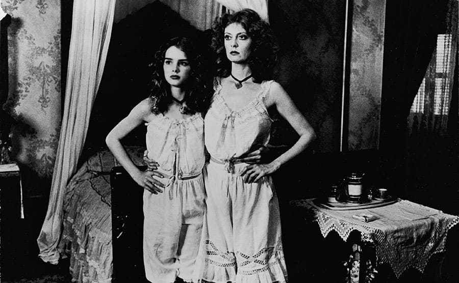 Brooke Shields and Susan Sarandon posing together in a bedroom in a scene from Pretty Baby