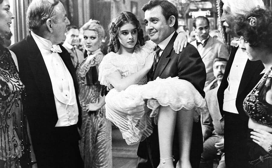 Brooke Shields being carried away by a man in the film ‘Pretty Baby’