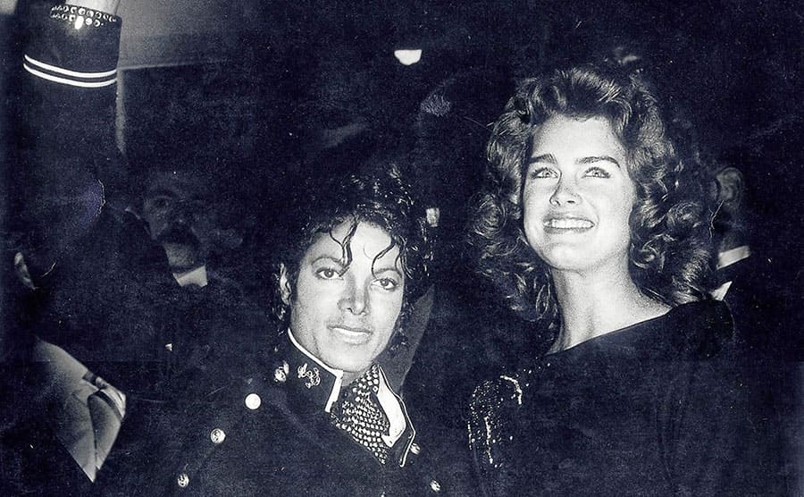 Michael Jackson waving while posing with Brooke Shields