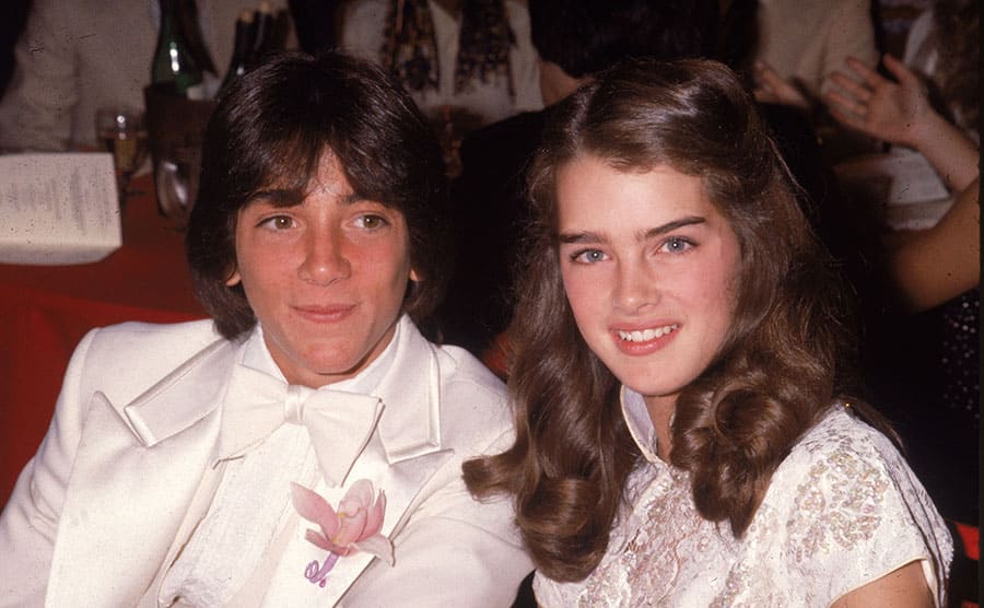 Scott Baio and Brooke Shields posing at a dinner event