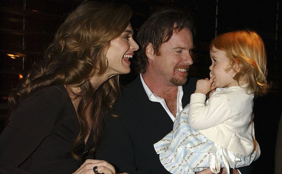 Brooke Shields and Chris Henchy giving some attention to their daughter Rowan at an event