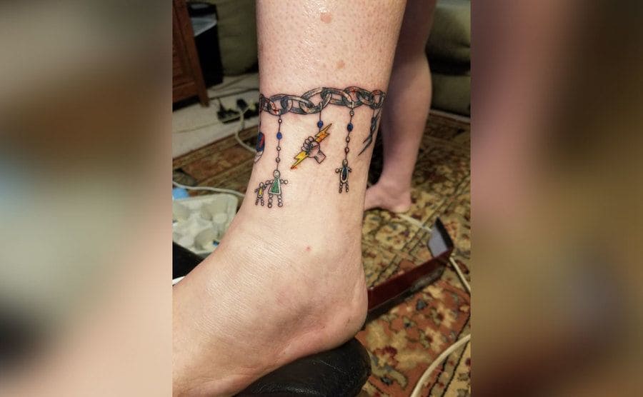 Shana’s ankle tattoo with the lightning bolt charm front and center.