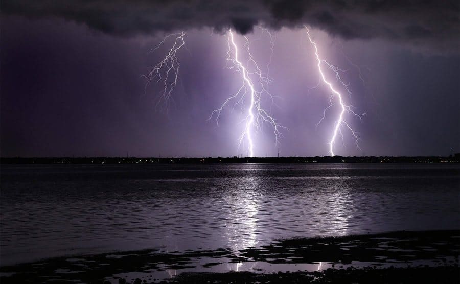 Two lightning rods striking the ground during a storm. 