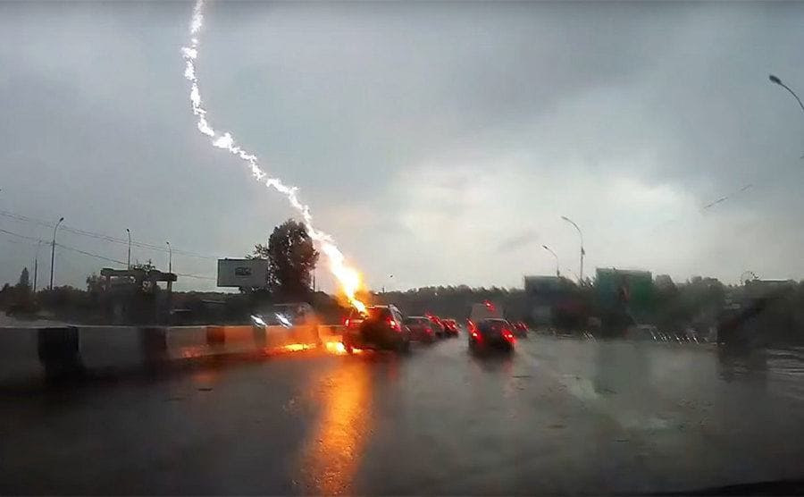 Lightning striking a vehicle in the middle of the road. 