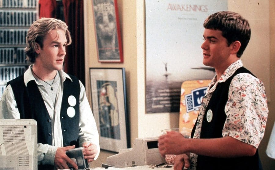 James Van Der Beek behind a counter with Joshua Jackson standing across from him talking